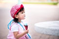Asian baby child Ã¢â¬â¹girl eating an ice-creamÃ¢â¬â¹ on a hot day. Adorable kid hold ice cream cone Royalty Free Stock Photo